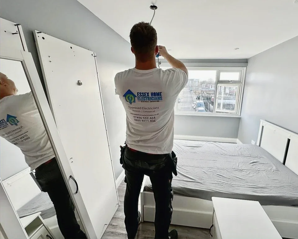 Essex Home Electricians installer working on a bedroom ceiling light